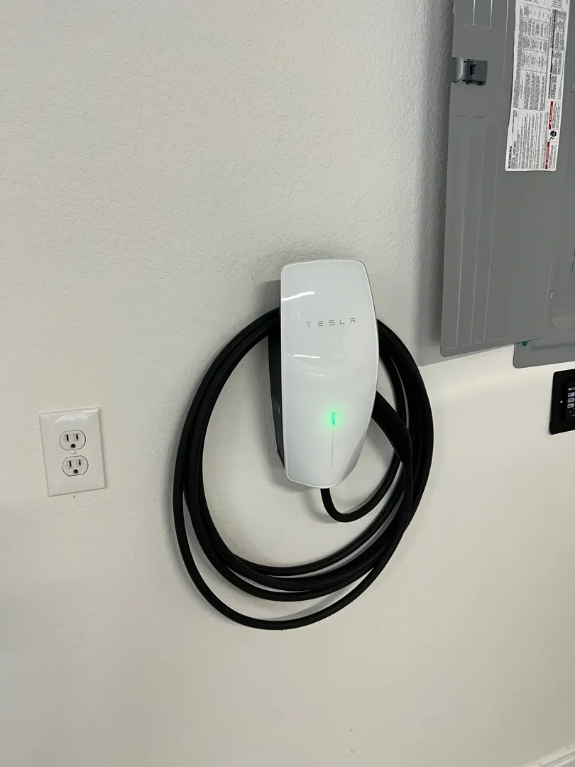 Tesla wall connector installed next to the inside breaker box
