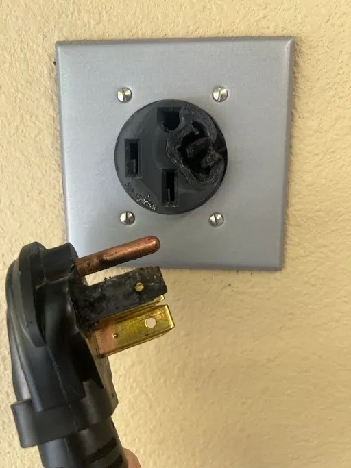 Melted NEMA 14-50 receptacle and cord end from a car charging station