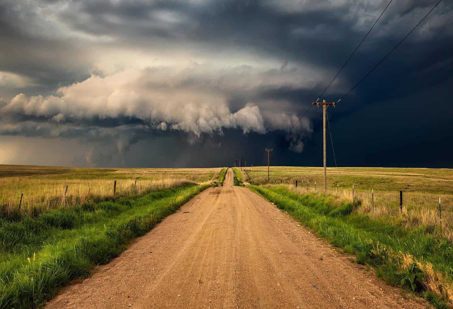 Storm beyond a dirt road